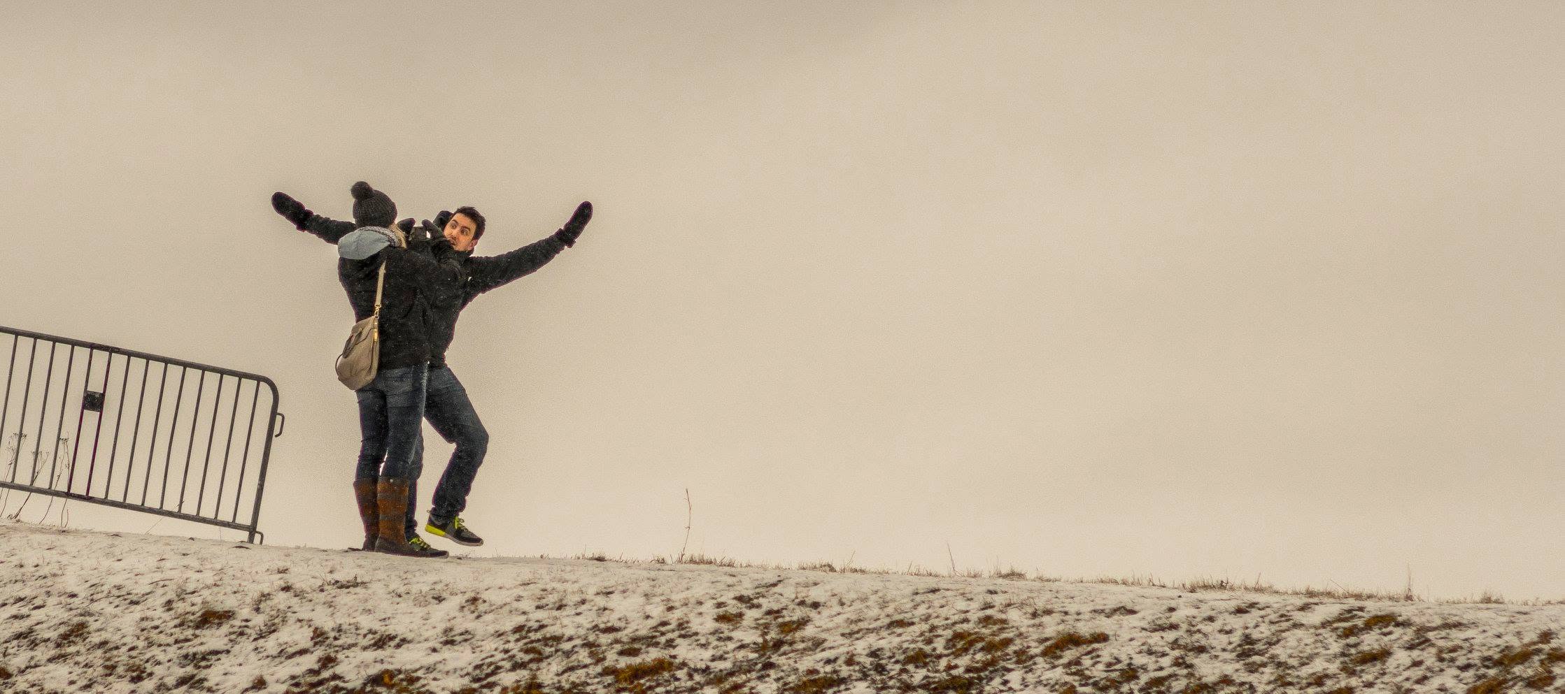 Couple posing on snowy hill