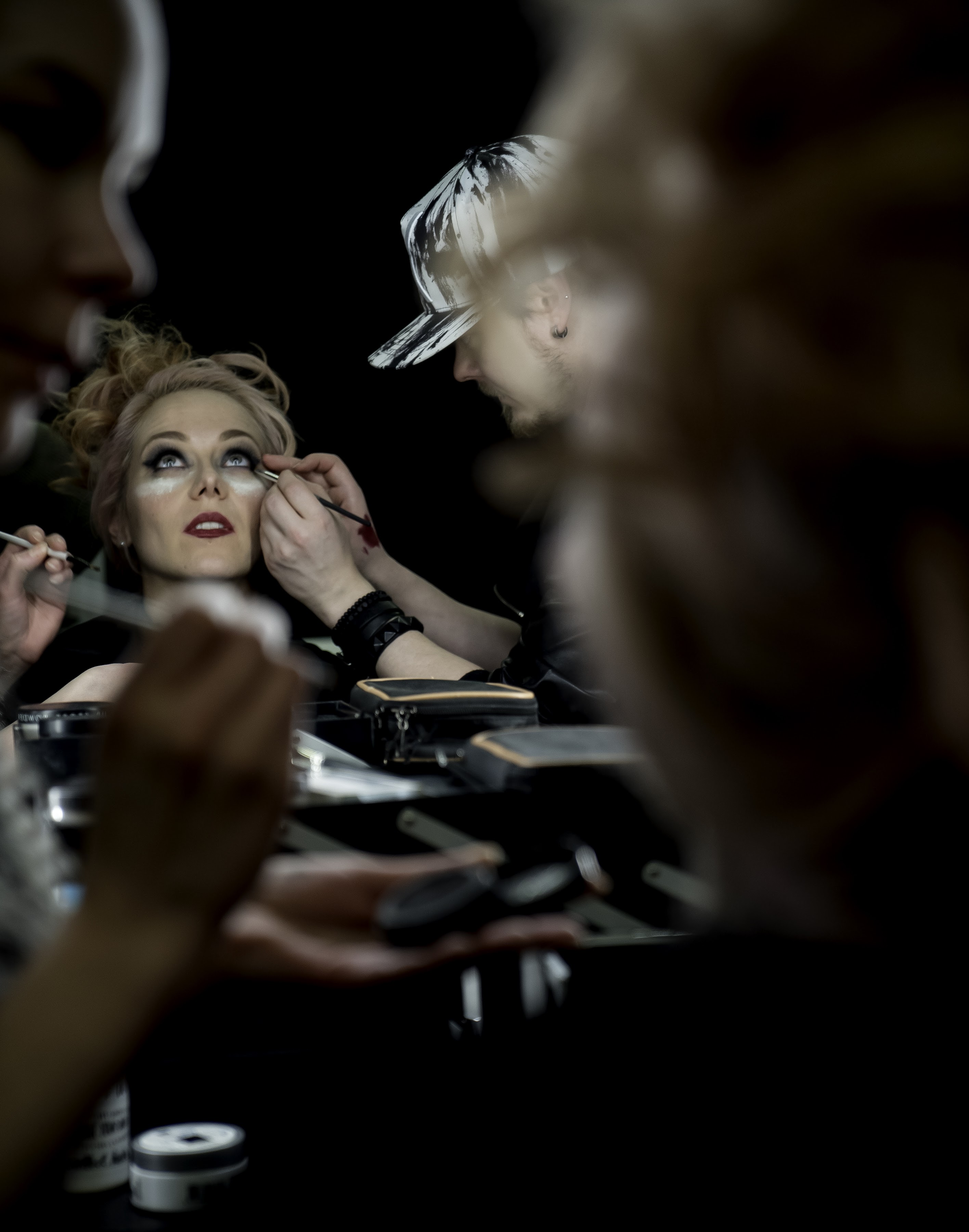 Makeup artist working on a model behind the scenes